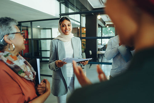Muslim businesswoman receiving an applause from her colleagues