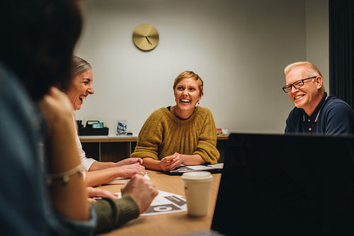 Cheerful colleagues looking happy in meeting