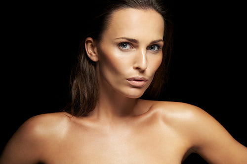 Stunning young brunette on black background