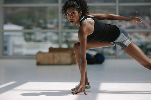 Healthy african woman working out in gym