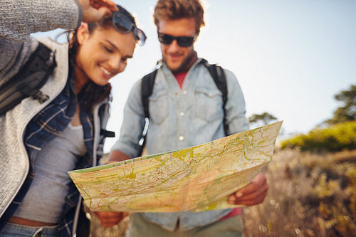 Couple reading map on country walk