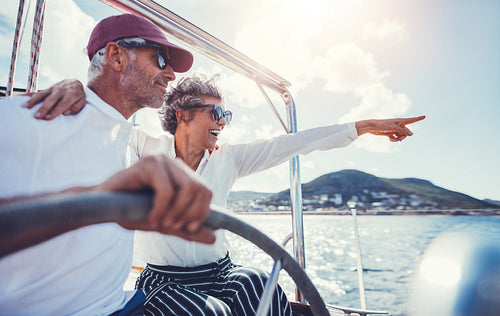 Happy senior couple having fun on a boat trip