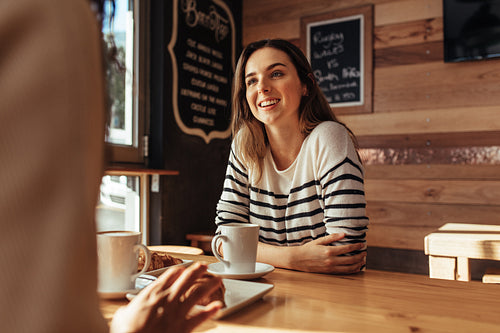 Friends sitting in a cafe and talking