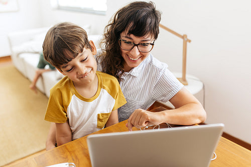Happy mother and son with laptop