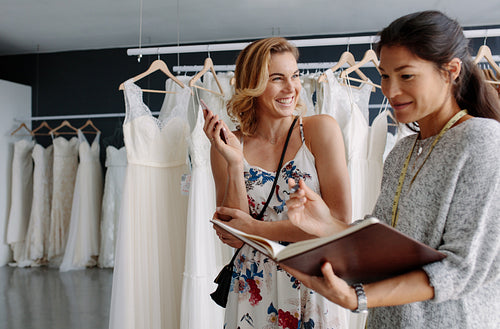 Bridal store owner taking order from client