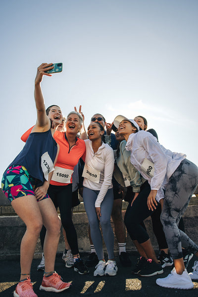 Joyful running club friends capturing a memorable event selfie