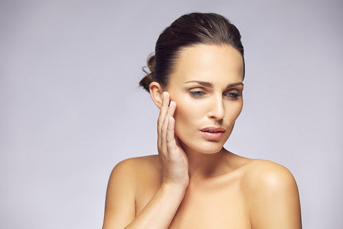 Woman caressing her beautiful skin