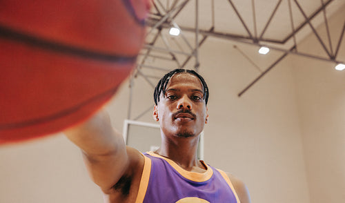 Focused basketball player holding the ball