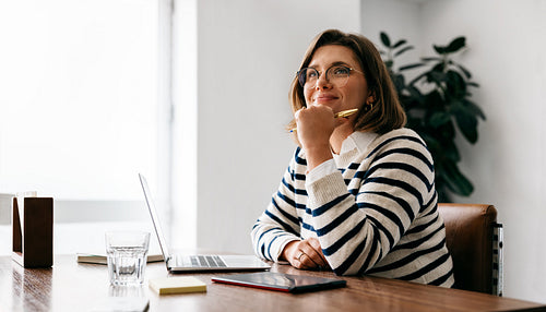 Planning guides the woman as she works on a laptop at her desk