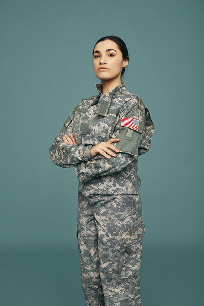 Brave young United States army soldier standing in a studio
