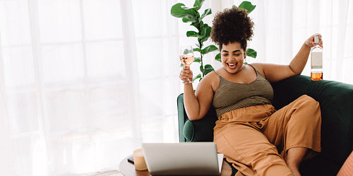 Woman having virtual happy hour party on video call