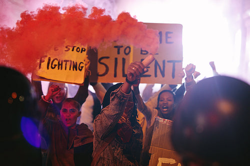 Group of people protesting with smoke grenades