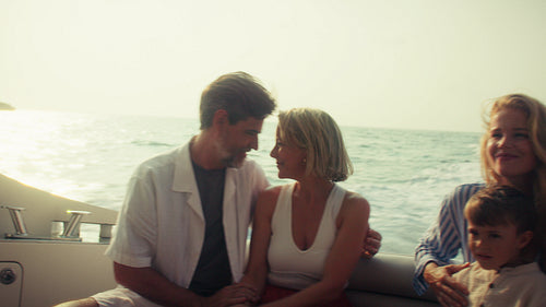 Family cruise on a yacht during sunset with loving parents, children and grandchildren
