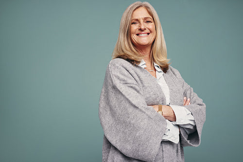 Senior woman smiling with her arms crossed