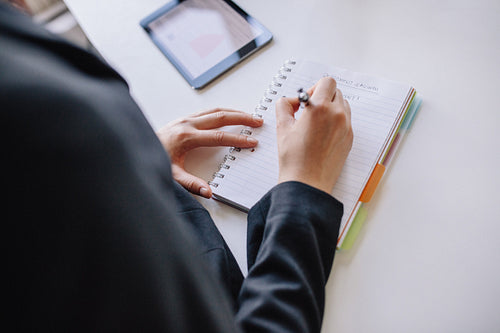 Businesswoman hands writing on notepad