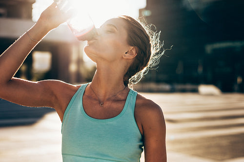 Woman drinking water after workout session