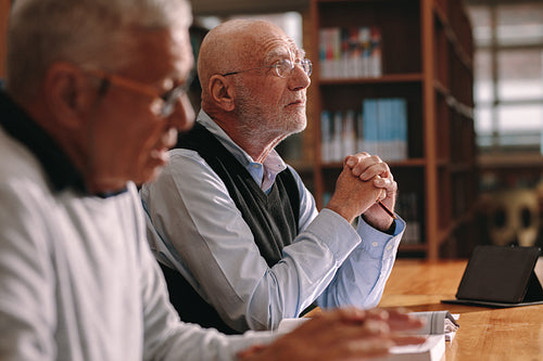 Senior men sitting in a classroom learning