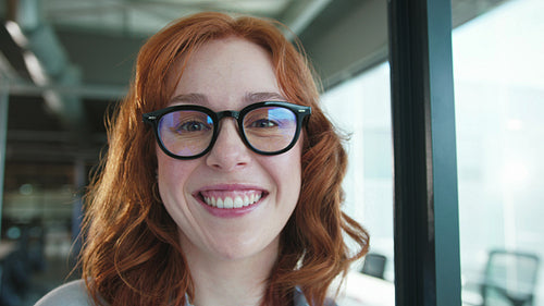 Business woman smiling at the camera in an office