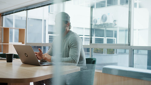Doing business remotely: Business man having a virtual meeting in a coworking office