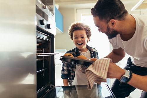 Man and son baking cookies at home