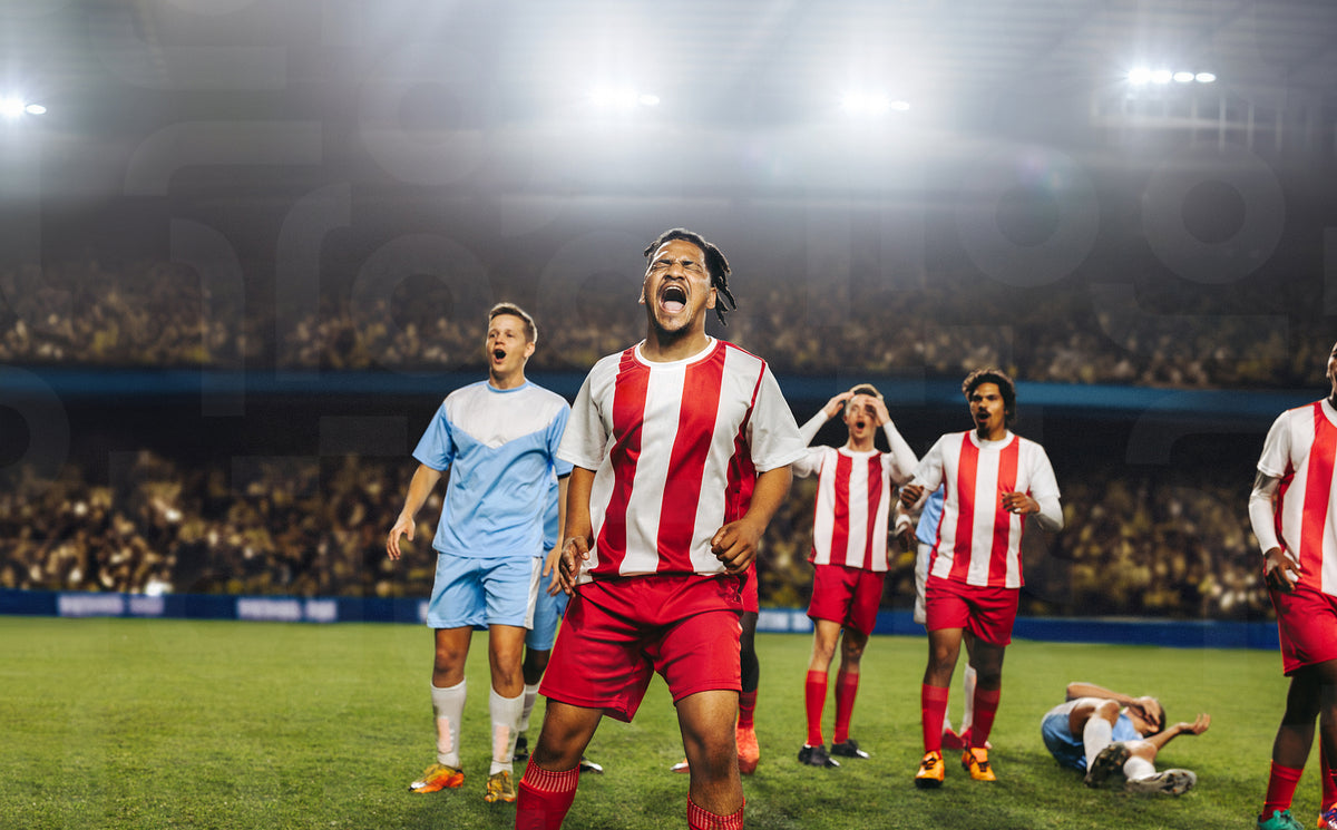 Professional football players reacting passionately during a match in ...