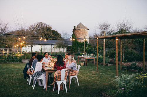 Group of men and women having outdoors party
