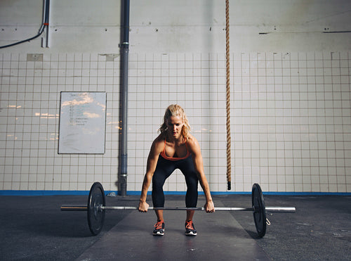 Fit female athlete performing a deadlift