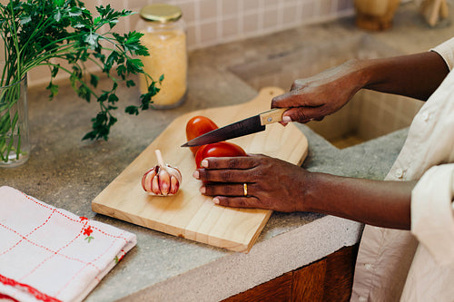 Female cook preparing Brazilian cuisine with fresh ingredients on chopping board