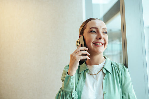 Confident caucasian woman on phone in office