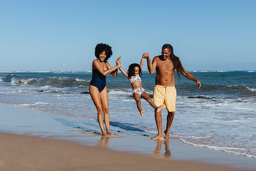 Happy family enjoying beach vacation on a warm summer day