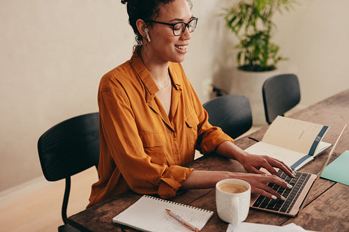 Businesswoman working on laptop at home office