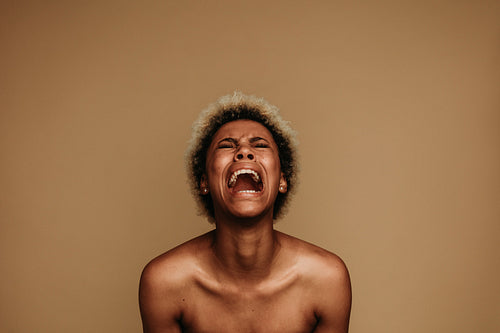 Portrait of african american woman shouting in pain