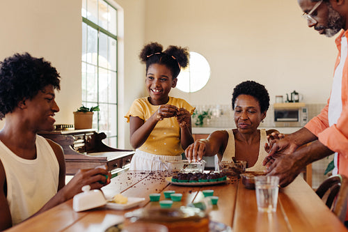 Mom, dad, and kids making traditional Brazilian brigadeiro together at home