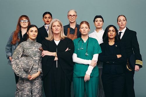 Portrait of different female workers standing in a studio