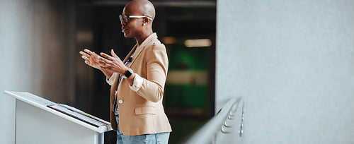 Mature businesswoman giving a presentation at a conference