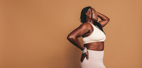 Mature woman standing in a studio in sportswear