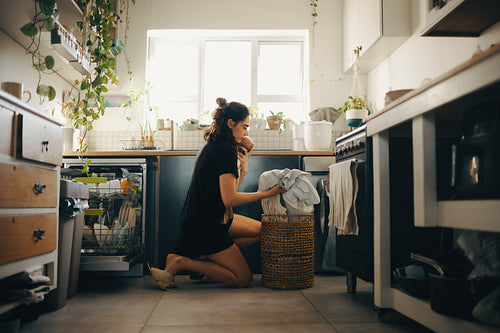 Mother on maternity leave balancing baby and house chores