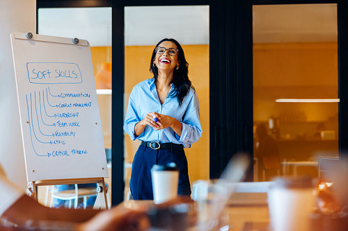 Woman presenting a workshop on soft skills development before an engaged audience