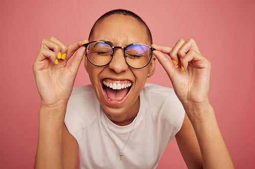 Excited and expressive creative woman wearing eyeglasses