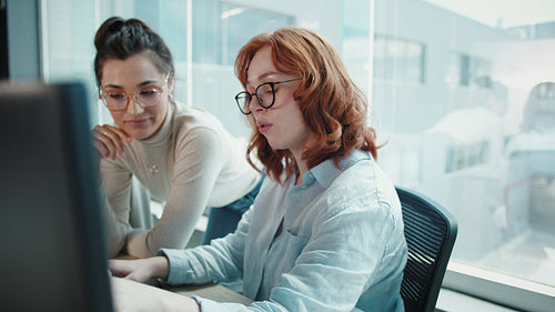 Women working on a code in an office