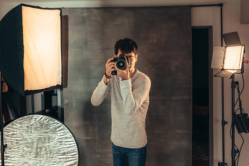 Professional photographer taking pictures in studio
