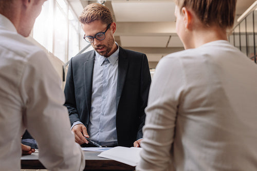 Young entrepreneur discussing new business plan with colleagues