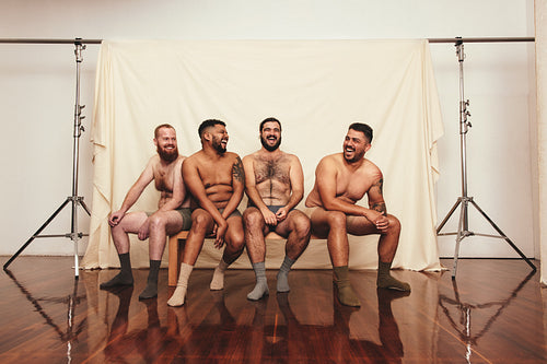 Happy men wearing underwear in a studio