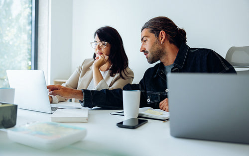 UX designers review concept ideas at desk