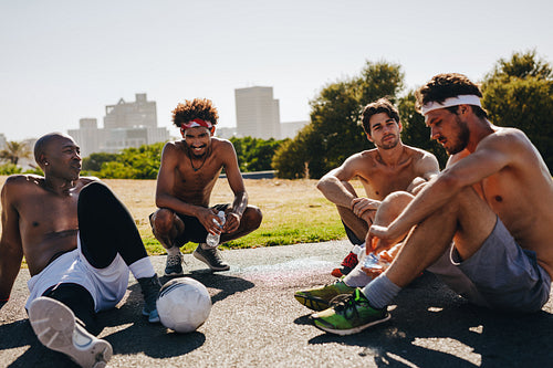 Men relaxing during a football game