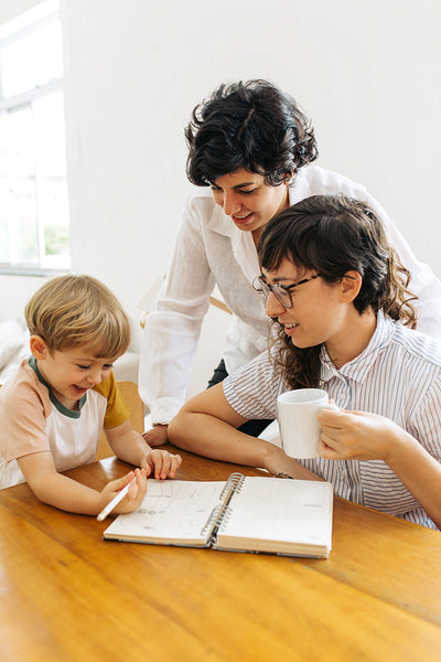 Boy having fun while studying with parents