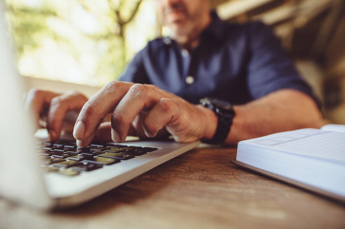 Man doing his work sitting at a coffee shop