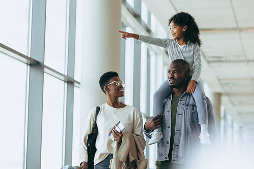 Happy family going on a holiday in airport