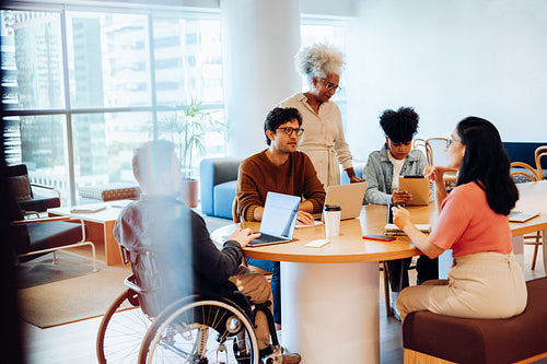 Collaboration around a round table in office workspace