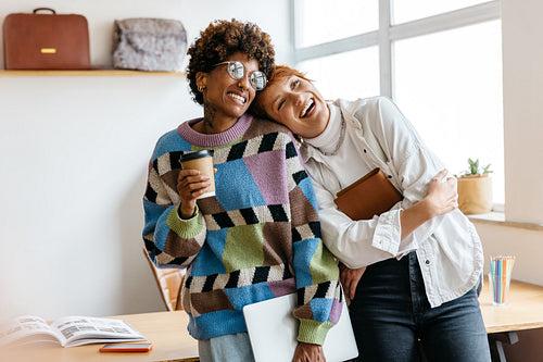Colleagues sharing a joyful moment in a co-working space